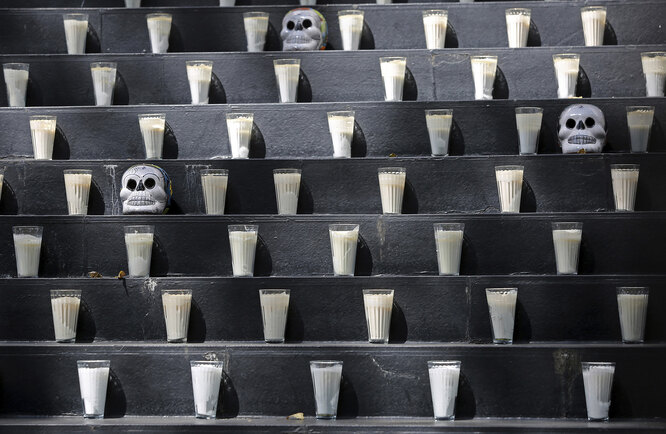 A Day of the Dead altar adorned with candles and skulls sits inside Senate in Mexico City, Saturday, Oct. 31, 2020. Mexico’s Day of the Dead celebration won’t be the same in a year so marked by death after more than 90,000 people have died of COVID-19. (AP Photo/Ginnette Riquelme)