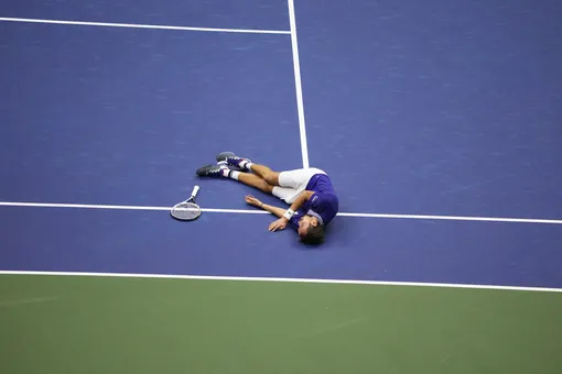 Russia's Daniil Medvedev drops to the ground in celebration of his win over Serbia's Novak Djokovic during their 2021 US Open Tennis tournament men's final match at the USTA Billie Jean King National Tennis Center in New York, on September 12, 2021. (Photo by TIMOTHY A. CLARY / AFP) (Photo by TIMOTHY A. CLARY/AFP via Getty Images)