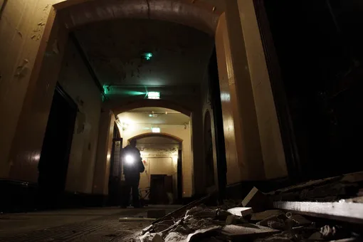 A Dublin City Council worker shines a torch over debris on the floor of the corridor in the now derelict Sisters of Our Lady of Charity Magdalene Laundry on Sean McDermott St in Dublin's north inner city on the day of The Irish Government has apologised to the thousands of women locked up in Catholic-run workhouses known as Magdalene laundries between 1922 and 1996. (Photo by Julien Behal/PA Images via Getty Images)