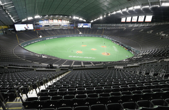 Spectator's stands are seen empty during the preseason baseball game of Hokkaido Nippon-Ham Fighters and Orix Buffaloes, which is taking place behind closed doors amid the spread of the new coronavirus, at the Sapporo Dome in Sapporo, Hokkaido, Japan February 29, 2020, in this Kyodo photo. Kyodo via REUTERS
