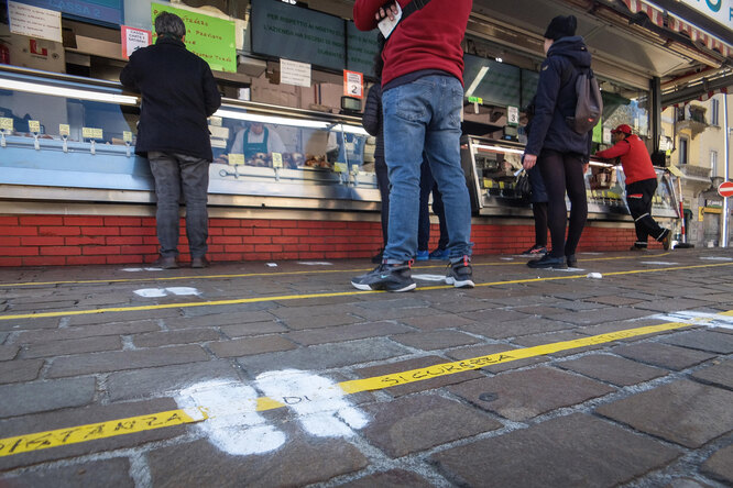 Lines and footprints drawn on the ground to ensure the safety distance between customers waiting in front of the street food Giannasi gastronomy in Buozzi square, Milan 11 March 2020, due to massive coronavirus related COVID-19 disease cases in Italy. EPA-EFE/Matteo Corner