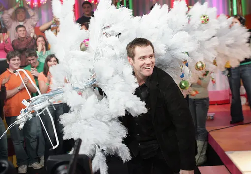 NEW YORK — DECEMBER 13: (US TABS OUT) Actor/Comedian Jim Carrey holds a white Christmas tree as he appears on stage during MTV's Total Request Live at the MTV Times Square Studios December 13, 2004 in New York City. (Photo by )