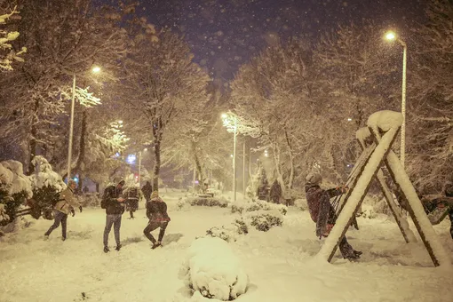 People throw snowballs each other on the snow-covered park in Istanbul, Turkey, on Monday, Jan. 24, 2022. A severe snowstorm disrupted road and air traffic Monday in the Greek capital of Athens and in neighboring Turkey's largest city of Istanbul, while snow blanketed most of Turkey and Greece, including several Aegean islands. (AP Photo/Emrah Gurel)