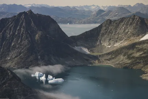n this photo taken on Wednesday, Aug. 14, 2019, icebergs are photographed from the window of an airplane carrying NASA Scientists as they fly on a mission to track melting ice in eastern Greenland. Greenland has been melting faster in the last decade and this summer, it has seen two of the biggest melts on record since 2012.