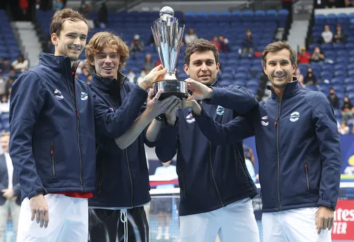 Russia's ATP Cup winners Daniil Medvedev, Andrey Rublev, Aslan Karatsev and Evgeny Donsky pose with their trophy after defeating Italy in the final in Melbourne, Australia, Sunday, Feb. 7, 2021.(AP Photo/Hamish Blair)