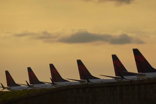 Delta Air Lines 737 passenger planes are seen lined up on a runway where they are parked due to flight reductions made to slow the spread of coronavirus disease (COVID-19), at Atlanta Hartsfield-Jackson International Airport in Atlanta, Georgia, U.S. March 21, 2020. Picture taken March 21, 2020. Elijah Nouvelage/REUTERS