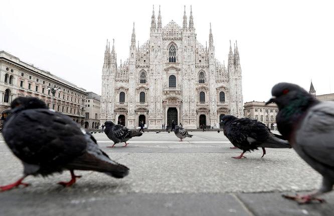DATE IMPORTED:March 05, 2020Pigeons roam around Piazza Duomo square after the government decree to close cinemas, schools and urge people to work from home and not stand closer than one metre to each other, in Milan, Italy, March 5, 2020. REUTERS/Guglielmo Mangiapane TPX IMAGES OF THE DAY