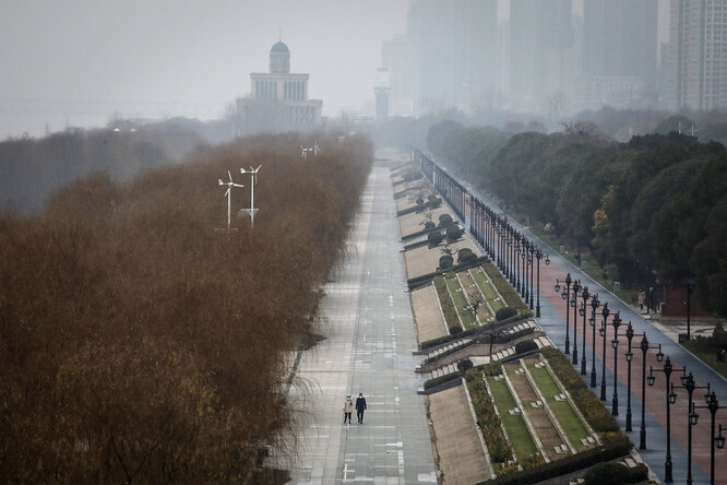 WUHAN, CHINA — JANUARY 27: (CHINA-OUT) Two residents walk in an empty Jiangtan park on January 27, 2020 in Wuhan, China. As the death toll from the coronavirus reaches 80 in China with over 2700 confirmed cases, the city remains on lockdown for a fourth day. (Photo by Getty Images)
