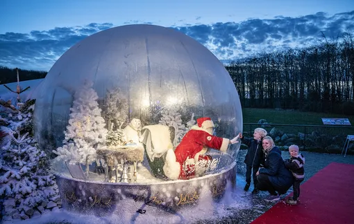Santa Claus in a life size snow ball made of plastic as a safety measure against coronavirus in Aalborg zoo, 13 November 2020. Christmas decorations and lightings have adorned Aalborg zoo, but in order to follow coronavirus restrictive and safety measures Santa Claus was put in a life size snow ball made of plastic to greet the kids without worrying about infections. . EPA-EFE/Henning Bagger