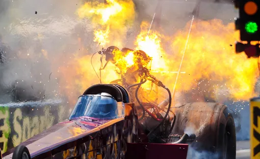 NHRA top fuel driver Kyle Wurtzel explodes an engine on fire during qualifying for the E3 Spark Plugs Nationals at Lucas Oil Raceway. This is the first race back for NHRA since the start of the COVID-19 global pandemic.