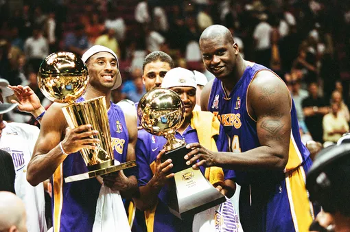 EAST RUTHERFORD, NJ — JUNE 12: Kobe Bryant, Lindsey Hunter and Shaquille O'Neal of the Los Angeles Lakers celebrate following Game Four of the NBA Finals against the New Jersey Nets on June 12, 2002 at Continental Airlines Arena in East Rutherford, New Jersey. (Photo by Sporting News via Getty Images via Getty Images)
