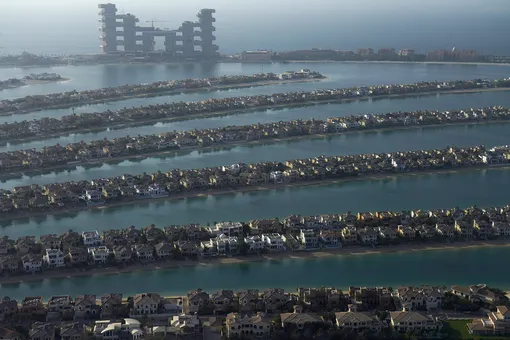 The fronds of the manmade Palm Jumeirah archipelago stretch out across the Persian Gulf with The Royal Atlantis Resort & Residences looming in the background in Dubai, United Arab Emirates, Monday, July 19, 2021.