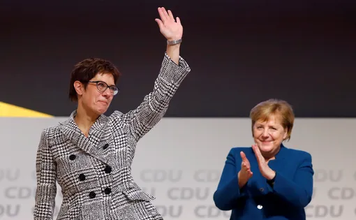 Annegret Kramp-Karrenbauer waves next to German Chancellor Angela Merkel after being elected as the party leader during the Christian Democratic Union (CDU) party congress in Hamburg, Germany, December 7, 2018. REUTERS/Kai Pfaffenbach