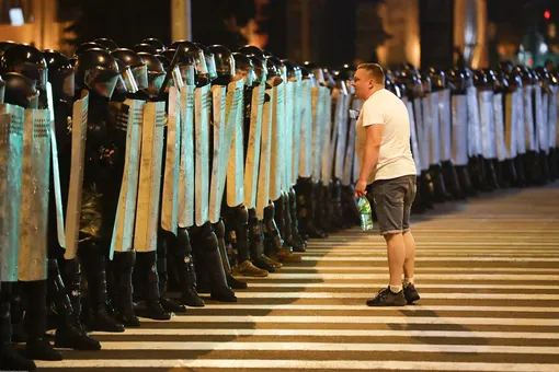 Один из протестующих говорит что-то полицейским во время митингов в Минске, Беларусь Один из протестующих говорит что-то полицейским во время митингов в Минске, Беларусь