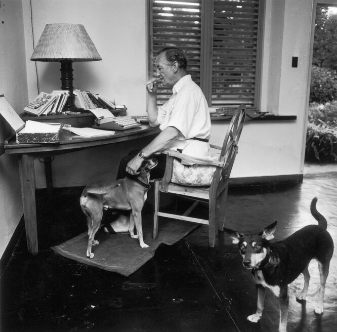 James Bond creator Ian Fleming writing at his desk at Goldeneye, his clifftop house in Jamaica, wearing his Rolex Explorer, 1964