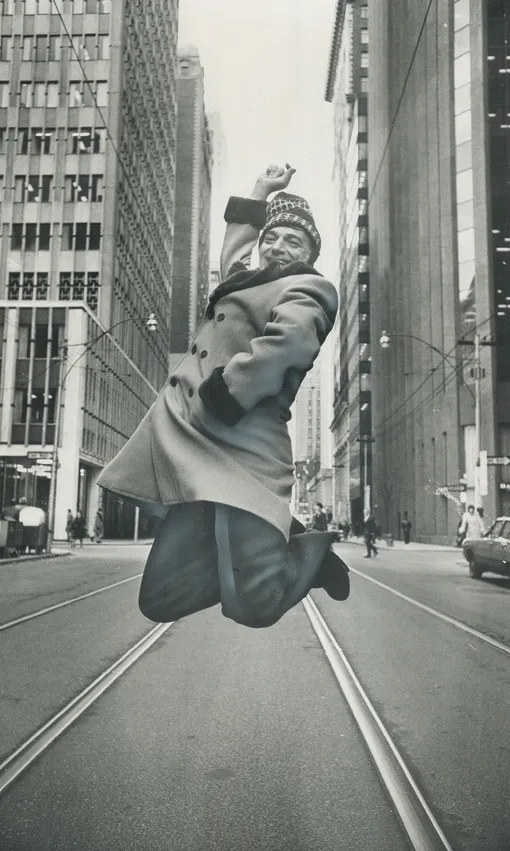 CANADA — JANUARY 25: Looking like a proper Canadian; with a red wool toque on his head; dancer Jose Greco; 56; yesterday leaped above the streetcar tracks on King St. as warmup to his performance last night at Eaton Auditorium. He's there again tonight. (Photo by )