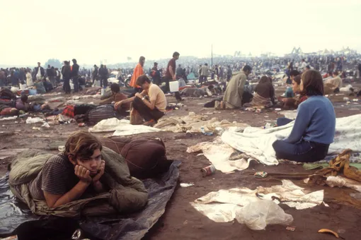 People in the messy field at the Woodstock Music Festival, New York, US, August 1969. (Photo by Owen Franken/Corbis via Getty Images))
