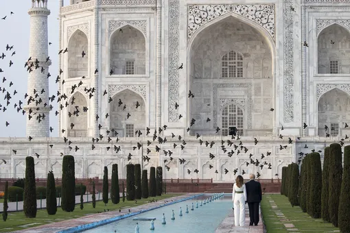 Birds fly as President Donald Trump, with first lady Melania Trump, tour the Taj Mahal, Monday, Feb. 24, 2020, in Agra, India. (AP Photo/Alex Brandon),
