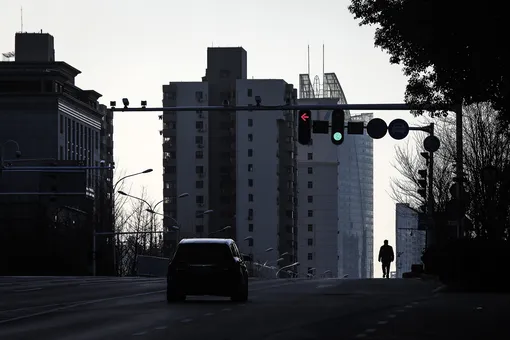 A man walk in the street at Optical Valley on February 16, 2020 in Wuhan, Hubei province, China. Flights, trains and public transport including buses, subway and ferry services have been closed for 25 days. The number of those who have died from the Wuhan coronavirus, known as 2019-nCoV, in China climbed to 1667. (Photo by Getty Images)