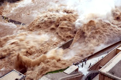 SANMENXIA, CHINA — AUGUST 28: People watch the water released by Sanmenxia Dam on August 28, 2019 in Sanmenxia, Henan Province of China. Sanmenxia Dam discharges water to prevent floods.