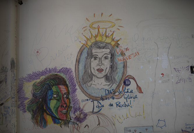 Drawings and messages honoring the transgender community decorate a wall of at the squat known as Casa Nem, occupied by members of the LGBTQ community who are in self-quarantine as a protective measure against the new coronavirus, in Rio de Janeiro, Brazil, Friday, May 29, 2020. New residents during the pandemic have to isolate on one of the building's floors for 15 days to ensure they don’t develop symptoms before fully joining the community.