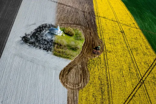 Four Seasons | Urban CommendedA lonely chapel in the middle of a field shot in the four seasons. This is the fifth in this series. A tractor is working the fieldPhotograph: Ovi D. Pop/Drone Photography Awards 2021