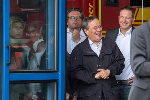 DOCUMENT DATE:July 18, 2021CDU leader and North Rhine-Westphalia's State Premier Armin Laschet laughs as the German president (unseen) delivers a speech during their visit to flood-hit Erftstadt, Germany July 17, 2021. Picture taken July 17, 2021 Marius Becker/Pool via REUTERS