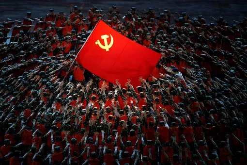 Performers rally around the Red Flag during a show commemorating the 100th anniversary of the founding of the Communist Party of China at the National Stadium in Beijing, China June 28, 2021. Thomas Peter / Reuters