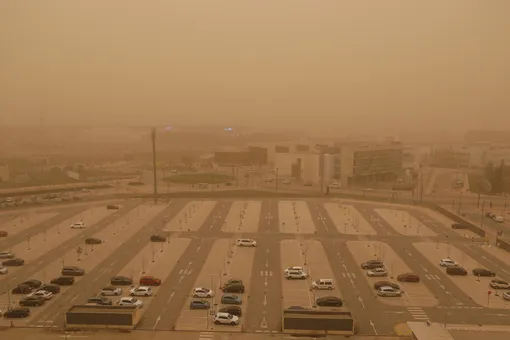 A general view of a parking area in Granada covered by a saharan dust haze on March 15, 2022. (Photo by Álex Cámara/NurPhoto via Getty Images)