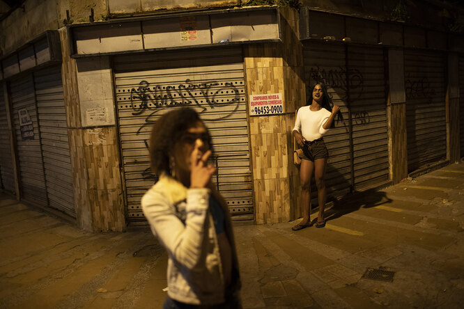 Transgender sex worker Alice Larubia smokes a cigarette as she waits for customers in Niteroi, Brazil, Saturday, June 27, 2020, amid the new coronavirus pandemic. After a month quarantining at home with some financial support from family, Larubia resumed work in Niteroi, a city across the bay from Rio. «Necessity spoke louder (than the pandemic) and I had to come back to the street,» Larubia said while waiting for clients with a small group of colleagues.