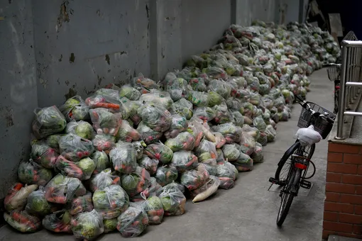Bags of vegetables are seen at a residential compound before the second stage of a two-stage lockdown to curb the spread of the coronavirus disease (COVID-19), in Shanghai, China March 31, 2022. REUTERS/Aly Song