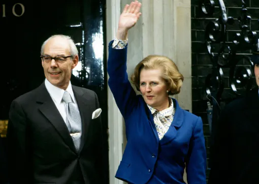 LONDON, UNITED KINGDOM — MAY 04, 1979: Prime Minister Margaret Thatcher, with husband Denis Thatcher, waves to well-wishers outside Number 10 Downing Street following her election victory, on May 4, 1979 in London, England. (Photo by Tim Graham/Getty Images)