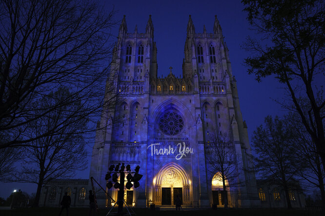 WASHINGTON, DC — APRIL 13: Washington National Cathedral is illuminated in blue with the words Thank You projected on the facade as a tribute to healthcare workers responding to the coronavirus pandemic, April 13, 2020 in Washington, DC. (Photo by Drew Angerer/Getty Images)