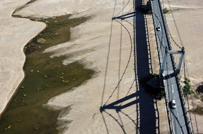 June 13, 2022 Cars pass over a bridge on a branch of the Loire River as a heatwave hits Europe, in Mauges-sur-Loire, France, June 13, 2022. Picture taken with a drone. REUTERS/Stephane Mahe