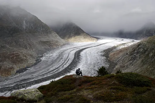 Stefanie enjoys the view of the Swiss Aletsch Glacier, in Valais, Switzerland, 25 September 2019 (issued 26 September 2019). The Swiss Aletsch glacier, one of the largest ice streams in Europe, is the first Unesco World Heritage Site of the Alps. This huge river of ice stretches over 23 km from its formation in the Jungfrau region (at 4000 m) down to the Massa Gorge in Valais, around 2500 m below.