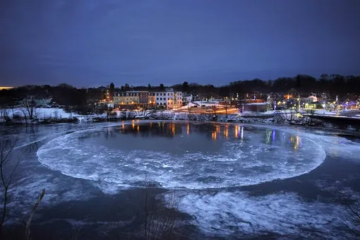 A large ice disk slowly rotates in the Presumpscot River in Westbrook, Maine, Thursday, Jan. 13, 2022. Ice disks form as a result of a current and vortex under the ice. (AP Photo/Robert F. Bukaty), APTOPIX