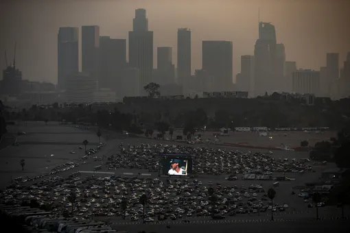 Los Angeles Dodgers' fans watch game two of the World Series 2020 between the Tampa Bay Rays and Los Angeles Dodgers, at a drive-in is organized on the grounds of Dodger Stadium (foreground) amid the coronavirus pandemic in Los Angeles, California, USA, 21 October 2020. EPA-EFE/ETIENNE LAURENT