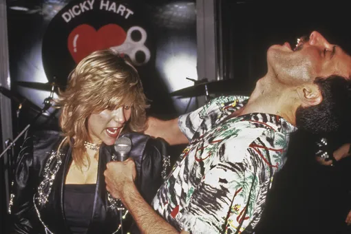 performs a duet with Samantha Fox during a party at Kensington Roof Gardens in London, 12th July 1986. The event is an after-party for Queen's sell-out Wembley concerts. (Photo by Dave Hogan/Getty Images