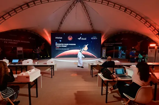 People wait for the launch of the «Hope» Mars probe at the Mohammed Bin Rashid Space Centre in Dubai on July 19, 2020. — The probe is one of three racing to the Red Planet, with Chinese and US rockets also taking advantage of the Earth and Mars being unusually close: a mere hop of 55 million kilometres (34 million miles). «Hope» — Al-Amal in Arabic — is expected to start orbiting Mars by February 2021, marking the 50th anniversary of the unification of the UAE. (Photo by Giuseppe CACACE / AFP) (Photo by GIUSEPPE CACACE/AFP via Getty Images)