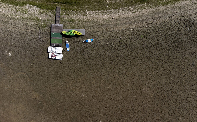 Kayaks, pedal boats and paddle boards are seen on the dried bed of the drought-affected Doubs River on the border with France in Les Brenets, Switzerland, August 8, 2022. REUTERS/Denis Balibouse