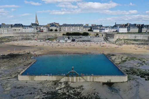 An aerial photograph taken on July 9, 2020 shows people enjoying a seawater pool on the beach of Saint-Malo, western France.