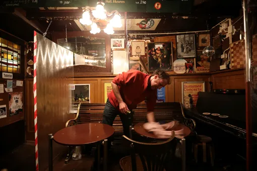 A man cleans a bar after it closed following the new restrictions announced by the Dutch government, as the Netherlands battle to control the spread of the coronavirus disease (COVID-19), in Amsterdam, Netherlands October 14, 2020. REUTERS/Eva Plevier