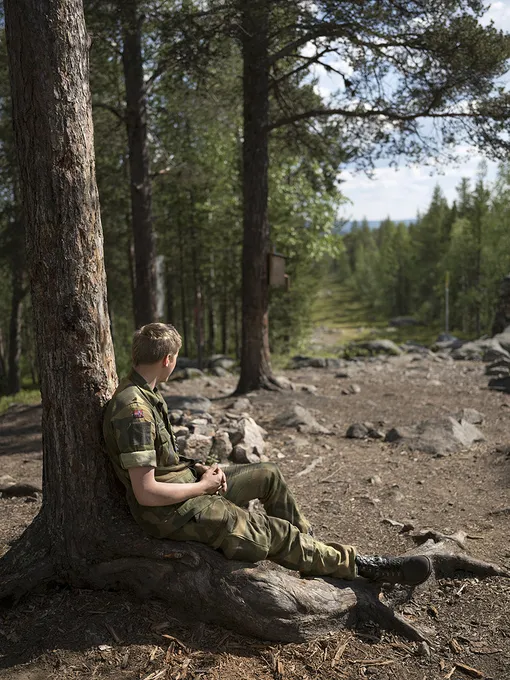 A Norwegian conscript takes a break while watching the Russian/Finnish/Norwegian border, at Treriksrøysa three-border zone