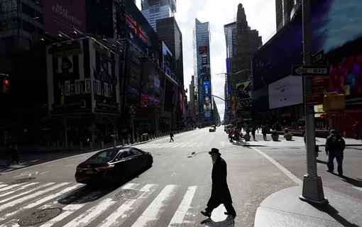 A person walks through a quiet Times Square in New York, New York, USA, 16 March 2020. New York, as with most cities around the United States and the world, are trying to mitigate the spread of the coronavirus and all restaurants and bars will be forced to close as of tonight. EPA-EFE/JUSTIN LANE